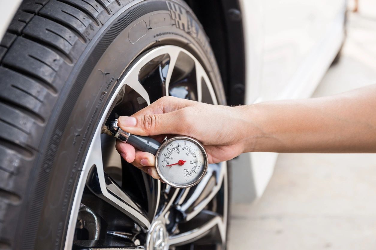 Person checking tire pressure
